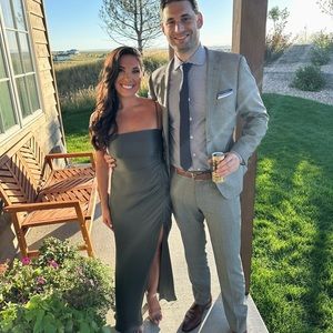 Maxi dress with ruched detailing at side split in a silk touch fabric.